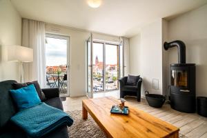 a living room with a couch and a coffee table at Möwe - Apartment in der Hafenresidenz mit Balkon & Wellness in Waren