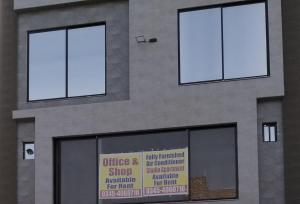 a building with three windows and a sign on it at Shabbir Premier Heights in Lahore