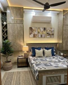 a bedroom with a bed and a ceiling fan at Shabbir Premier Heights in Lahore