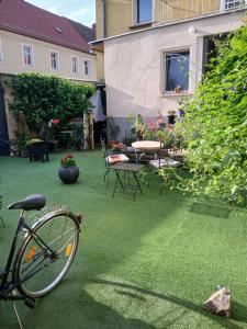 a bike parked on a lawn in a yard at Pension Ambiente in Mühlberg