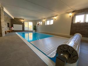 a large swimming pool in a building at Penzion Mühl in Bedřichov