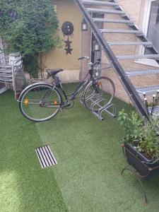 a bike parked on the grass next to a staircase at Pension Ambiente in Mühlberg