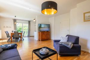 a living room with a couch and a table at Haus Sonnenschein 2 in Ahrenshoop