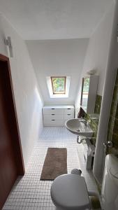 a small bathroom with a toilet and a sink at Heimathafen Neumünster in Neumünster
