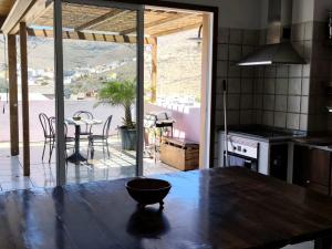 a kitchen with a table and a view of a patio at Gomera Isla Mágica in San Sebastián de la Gomera