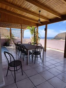 a table and chairs on a patio with the beach at Gomera Isla Mágica in San Sebastián de la Gomera