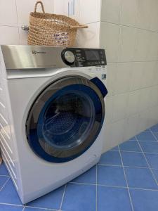a washing machine with a basket on top of it at Orizzonte Blu by HolAp SA in Gambarogno
