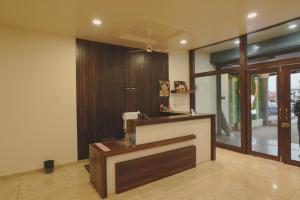 a lobby with a reception desk in a house at Hotel Ayodhya Inn in Lokāpur