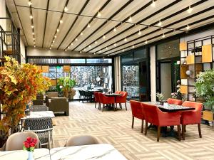 a restaurant with red chairs and tables in a building at Niconya Port Suite&Hotel in Istanbul