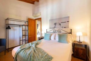 a bedroom with a white bed with blue pillows at Can gallu in Moscari +31 photos