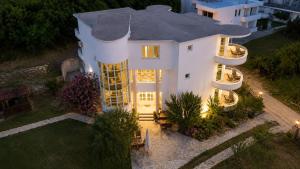 an aerial view of a white house at night at Apartments Katana in Ulcinj