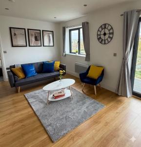 a living room with a couch and a table at Modern 2 Bed Flat, Free Parking, Central Hemel in Hemel Hempstead