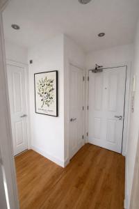 an empty room with white walls and wooden floors at Modern 2 Bed Flat, Free Parking, Central Hemel in Hemel Hempstead