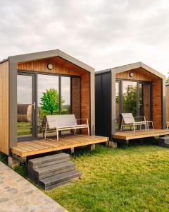 a modular house with two benches and windows at Zen Resort & SPA in Purcari