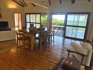 a living room with a table and chairs and a couch at Kangela 14 in Ponta Malangane