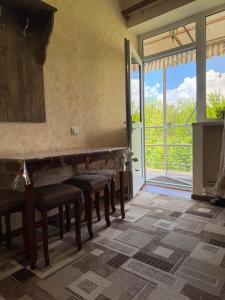 a room with some chairs and a large window at Norik guest house in Garni