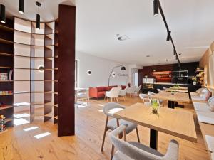 a living room with wooden tables and chairs at Apartmány Pod Jabloní in Jablonné nad Orlicí +14 photos