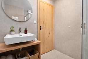 a bathroom with a sink and a mirror at Apartmány Pod Jabloní in Jablonné nad Orlicí
