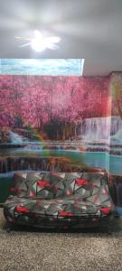 a bed in front of a painting of a waterfall at Apartamento de 100 M2 con 3 habitaciones y 2 terrazas in El Verger