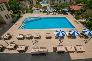 an overhead view of a swimming pool with tables and umbrellas at Kilim Hotel & Apart in Fethiye
