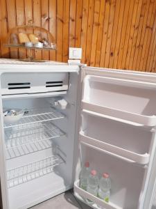 an open refrigerator with bottles of water in it at La Cà De Zan in Mezzegra