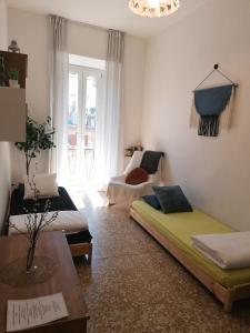 a living room with two beds and a table at La Cà De Zan in Mezzegra