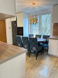 a kitchen and dining room with a table and chairs at Casa Horeb Apuseni in Sohodol
