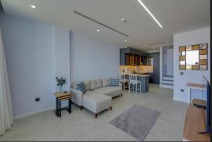 a living room with a couch and a table at FOR LARGE FAMILIES, DUPLEX Vılla-304 in Çeşme