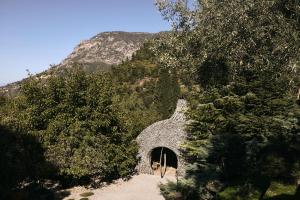 a tunnel in the side of a mountain with trees at Area Synest Nature Suites in Sinevrón