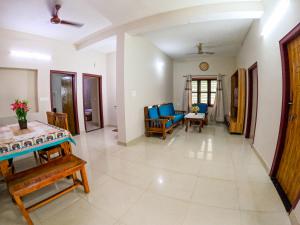 a living room with a couch and a table at Aranya Ocean Breeze in Mangalore