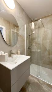 a white bathroom with a sink and a shower at Apartbaltic- Ventus Park 5 in Świnoujście