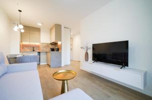 a living room with a large flat screen tv at Apartbaltic- Ventus Park 5 in Świnoujście