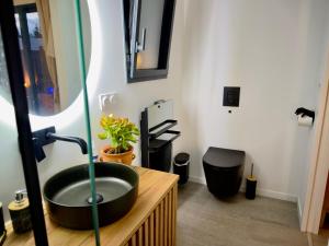 a bathroom with a black sink in a room at Maison des Chênes 64 - Spa Lodge in Boucau +23 photos