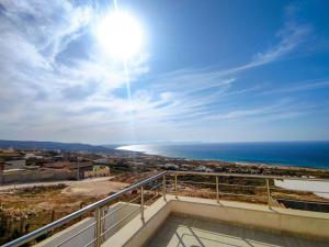 a view of the ocean from the balcony of a house at Dar Bourri in Al Matlīn