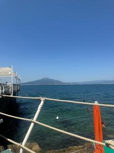 a group of people in the water near a pier at Villa Pina in Vico Equense