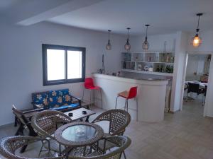 a living room with a couch and chairs and a table at Dar Bourri in Al Matlīn