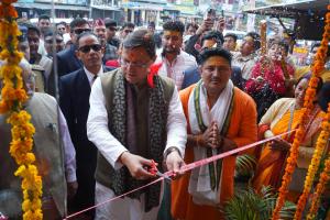 a woman cutting a ribbon in a crowd of people at Hill Mountain Hotel in Chakarpur