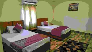 a room with two beds and a window at Hill Mountain Hotel in Chakarpur