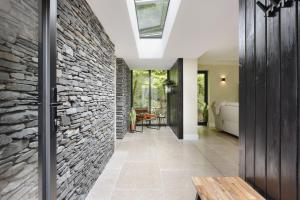 a hallway with a stone wall and a skylight at Fawns Keep - Ridgestone in Bowland Bridge