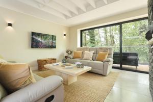 a living room with a couch and a table at Fawns Keep - Ridgestone in Bowland Bridge