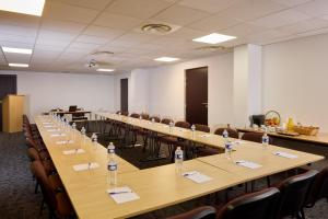 a large conference room with a long table and chairs at Zenitude Swiss Apparthotels in Ferney-Voltaire +53 photos