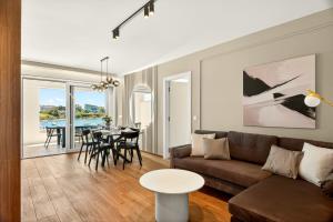 a living room with a couch and a table at Smile Apartments in Povljana