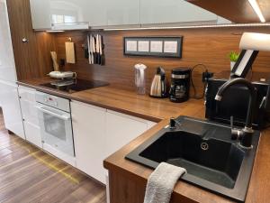 a kitchen with a sink and a counter top at Apartament Crooked stairs in Zielona Góra