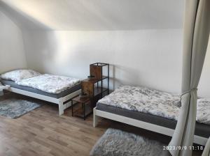 two beds sitting in a room with at Pferdepension Jäger in Markranstädt