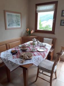 a dining room table with a table cloth on it at Le chalet du Chardonneret in Soultzbach-les-Bains