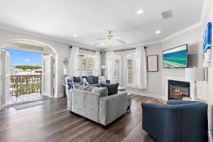 a living room with a couch and a fireplace at The Blue Lagoon in Rosemary Beach