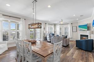 a dining room and living room with a table and chairs at The Blue Lagoon in Rosemary Beach