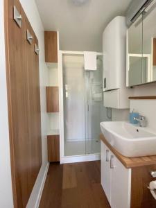 a bathroom with a white sink and a shower at Floating house Sunflower in Pula +25 photos