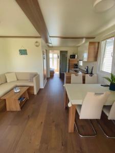 a living room with a couch and a table at Floating house Sunflower in Pula