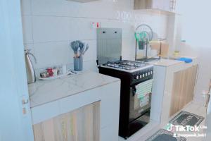 a small kitchen with a stove and a sink at Purity homes ruiru in Ruiru